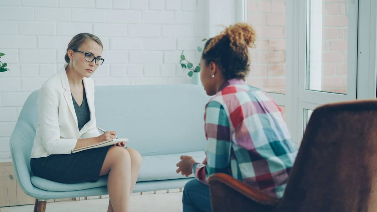 A therapist listening to a client during a counseling session